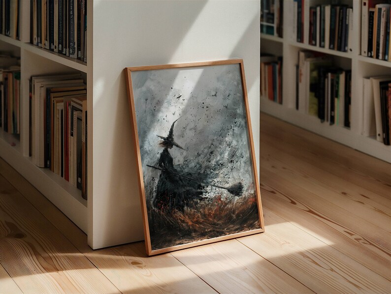 May include: A framed painting of a witch flying on a broomstick in a stormy sky. The painting is done in shades of gray and black with splashes of brown and white.