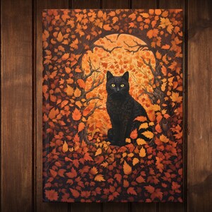 May include: A black cat sits in a circle of orange, yellow, and brown leaves. The cat has green eyes and is looking directly at the viewer. The background is a dark brown wood.