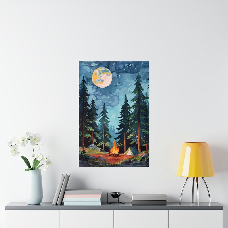 May include: Watercolor painting of a nighttime forest scene with a campfire, tent, and a full moon. Tall green trees frame the scene under a starry sky. The campfire glows with orange and yellow flames, creating a warm focal point.
