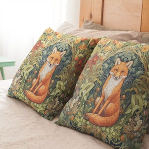 May include: Two decorative throw pillows with a green, brown, and orange fox design. The pillows are on a beige bed with a wooden headboard.