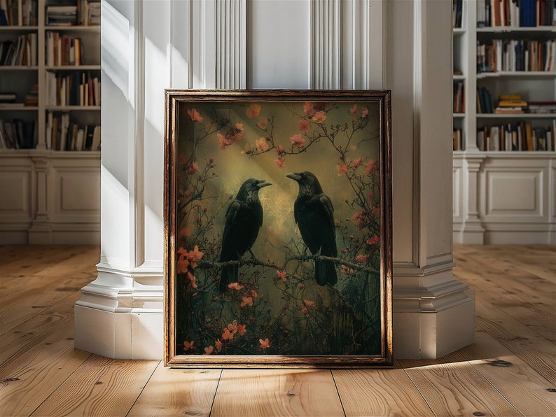 May include: A framed print of two black crows perched on branches in a forest setting. The crows are facing each other and the background is a soft green and brown with pink flowers.