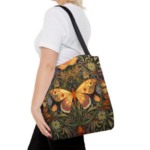 This beautiful tote bag features a brilliantly colored and highly detailed butterfly surrounded by flowers and foliage. The butterfly is yellow, red, pink, blue, gray, and brown.  The flowers and print reflect the similar colors, all on a black  back