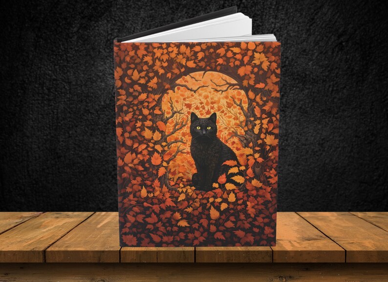 May include: A black cat with yellow eyes sits in a circle of orange and brown leaves. The cat is looking directly at the viewer. The background is a dark orange and brown.