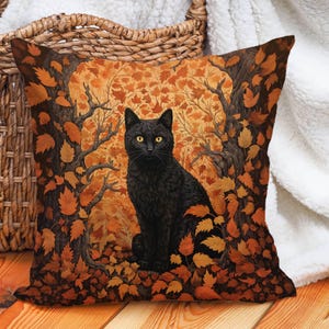 This gorgeous faux suede black cat pillow cover is the perfect addition to your fall witchy decor! The black cat is facing forward and surrounded by Autumn colored leaves and framed by two trees. Colors are rich, varying shades of orange and brown.