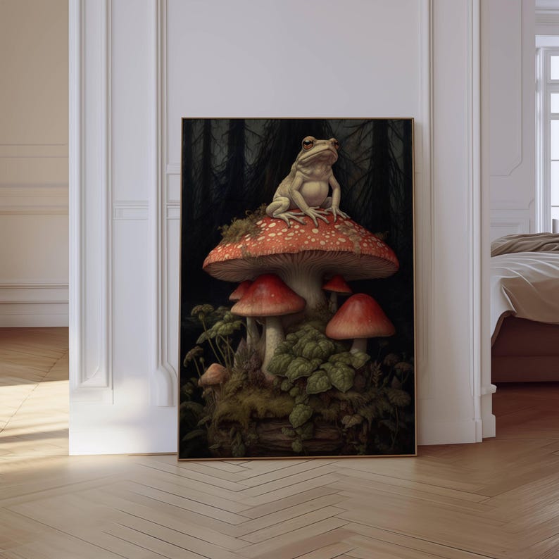 May include: A white frog sits on top of a red and white mushroom with a dark forest background. The mushroom is surrounded by other mushrooms and green foliage.