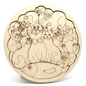 May include: A wooden puzzle featuring a circular design of numerous cartoon cats surrounding a fish. The cats are intricately carved with detailed facial expressions and some wear bow ties. The puzzle is made of light-colored wood.