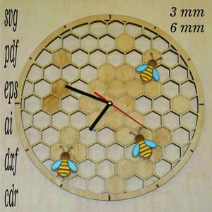 May include: A wooden clock with a honeycomb design and three bees. The clock face is made of wood and has a black hour hand and a red minute hand. The clock is available in two sizes: 3 mm and 6 mm.