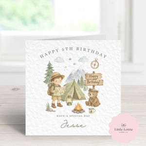 May include: A birthday card with a camping theme, featuring a watercolour illustration. The design includes a young explorer, tent, campfire, and a teddy bear. Text reads "Happy 5th Birthday", "Have a special day", and the name "Jesse".
