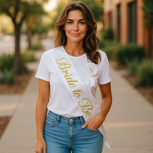 May include: A set of three ceramic mugs with a speckled, matte finish. The mugs are in shades of cream, light gray, and dark gray. Each mug has a simple, minimalist design and a rounded handle.