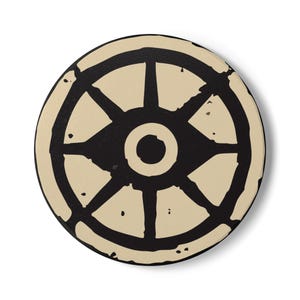 May include: Round coaster with a black and cream-colored design. The coaster features a central circle with a smaller circle inside, surrounded by a wheel-like pattern. The cream-colored sections have a distressed, aged appearance.