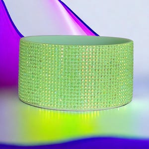 May include: A light green ceramic bowl with a sparkly iridescent finish. The bowl is covered in small, evenly spaced rhinestones.