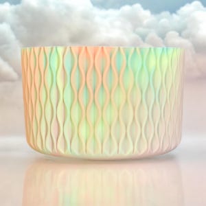 May include: A white ceramic bowl with a wavy, textured pattern. The bowl has a light blue, pink, and yellow ombre effect.
