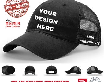 May include: A black trucker hat with a mesh back and a solid front panel featuring the white text YOUR DESIGN HERE. The side of the hat includes the text Side embroidery. Additional views show the hat from various angles including the back.