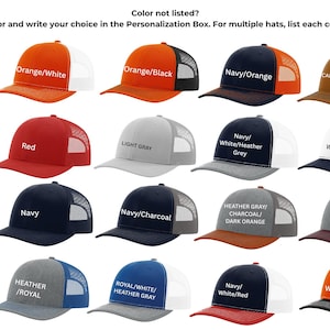 May include: A collection of trucker hats in various colors, including orange, navy, and purple, with white mesh backs. Each hat displays a different color combination, with text labels indicating the color scheme. The hats are displayed on a white background.