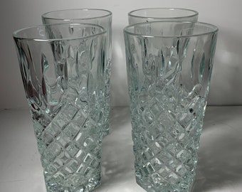 May include: Set of four clear glass drinking glasses with a diamond pattern.