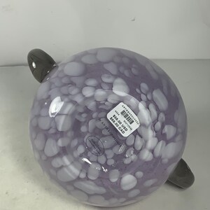 May include: Purple glass bowl with white polka dots and two grey handles. The bowl has a price tag attached that reads "&pound;58.00 USD &pound;68.00 CAD" and "Anthropologie".