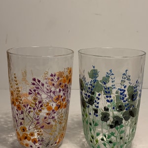 May include: A set of three ceramic mugs with a speckled, matte finish in cream, light grey, and dark grey. Each mug has a simple, modern design and a rounded handle. Ideal for tea or coffee.