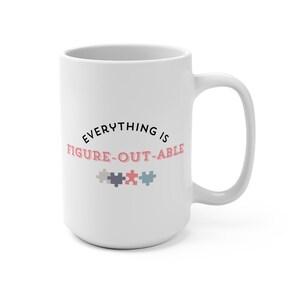 May include: White ceramic mug with the text "EVERYTHING IS FIGURE-OUT-ABLE" in black and pink. Below the text are three puzzle piece graphics in gray, navy, pink, and light blue. The mug has a large handle.
