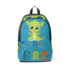 May include: A blue backpack with a green dragon illustration and the text "LITTLE BRO" in colorful letters. The backpack has a black zipper and a black handle.