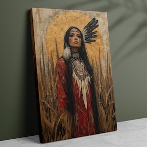 May include: A canvas print depicting a woman in Native American dress. She wears a red dress, a feathered headdress, and jewellery. The background features a golden halo and wheat stalks, creating a serene and artistic composition.