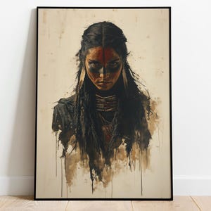 May include: A framed wall art print featuring a portrait of a person with long dark hair, wearing a layered necklace and face paint with red and black markings. The artwork has a distressed, watercolor-style aesthetic with drips of black ink.