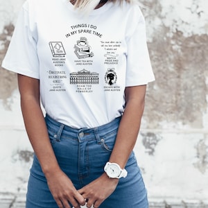 May include: White t-shirt with a black graphic design featuring a list of things to do in one's spare time, including reading Jane Austen's books, having tea with Jane Austen, watching Pride and Prejudice, roaming the halls of Pemberley, and escaping with Jane Austen.