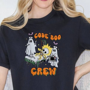 May include: A black t-shirt with a graphic of a skeleton in a hospital bed with two ghosts. The text "CODE BOO CREW" is printed on the shirt.