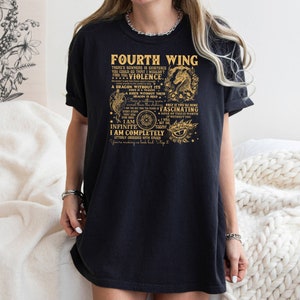 May include: Black t-shirt with a gold graphic print that reads "Fourth Wing" and includes a dragon design. The text includes the words "I am Infinite, I am Completely, Fascinating, Violence, Dragon without its Fire".