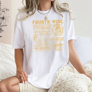 May include: White t-shirt with a gold graphic print that reads "Fourth Wing" and includes a dragon illustration. The text includes the phrases "There's nowhere in existence you could go that I wouldn't find you", "I am infinite", and "I am completely utterly obsessed with you".