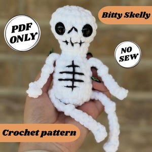 May include: A white crochet skeleton doll with black eyes and a black rib cage design. The doll has the text "Bitty Skelly", "PDF ONLY", "NO SEW", and "Crochet pattern" in the image.