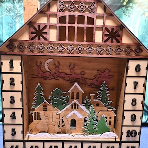 Large lighted Christmas advent calendar with 24 drawers to hide treats for each day!