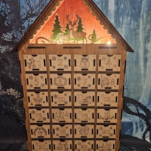 Lighted Christmas advent calendar with 24 drawers to hide treats for each day!