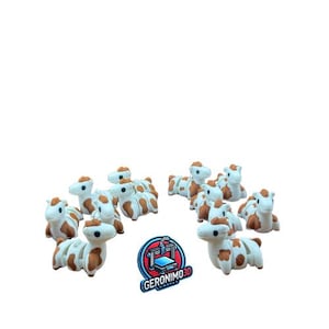 May include: A collection of small, white and brown cow figurines. The figurines have brown spots and are arranged in a semi-circle. The logo "GERONIMO3D" is visible in the bottom center.