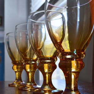 May include: A set of three ceramic mugs with a speckled, matte finish. The mugs are in shades of cream, light brown, and dark brown. Each mug has a simple, minimalist design, perfect for coffee or tea.