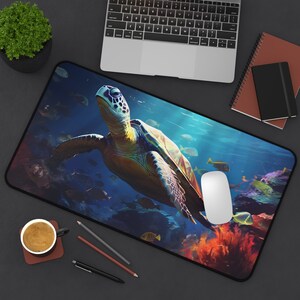 May include: A colorful mousepad featuring a green sea turtle swimming in a blue ocean with coral reefs and fish. The turtle has a brown shell and is swimming towards the right side of the image.