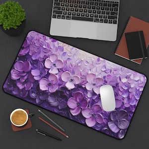 May include: Purple and white floral mouse pad with a white mouse on top. The mouse pad has a textured, brushstroke-like design.