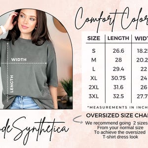 May include: Size chart for a t-shirt dress in sizes S to 3XL. The chart shows the length and width of the shirt in inches. The text "Comfort Colors" and "Code Synthetica" are also visible. The chart recommends going up two sizes for an oversized look.