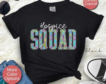 May include: Black t-shirt with the text "Hospice Squad" in white letters with a colorful patterned design. The text is in a varsity style font.
