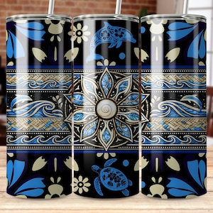 May include: A cylindrical stainless steel tumbler featuring a dark blue and gold pattern with a central mandala-style flower, a leaping dolphin, a sea turtle, and wave motifs. The design includes intricate geometric bands and floral elements.