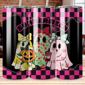 May include: Three stainless steel tumblers with a black and pink chequered pattern. Each tumbler features a ghost design with fruit and bow accents. The word "SUMMERWEEN" is written across the top. One ghost holds a pumpkin, another a drink.
