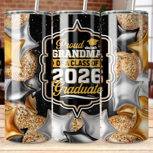 May include: A black and gold tumbler with the text "Proud Grandma of a Class of 2026 Graduate." The tumbler is decorated with gold and silver star-shaped balloons and confetti. A white straw is inserted into the lid.