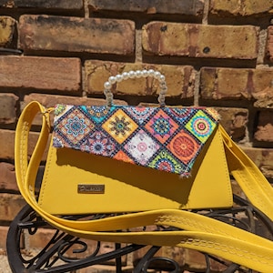 Cartera de tapa dura con diseño de azulejos mexicanos amarillos, asa de perla y correa cruzada