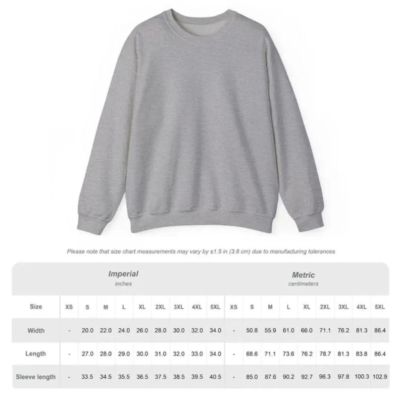 Puede incluir: Una sudadera gris jaspeada con cuello redondo. La imagen incluye una tabla de tallas con medidas en pulgadas y cent&iacute;metros. El ancho de la sudadera var&iacute;a de 50,8 a 86,4 cm y el largo de 68,6 a 86,4 cm.