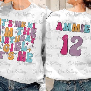 May include: White sweatshirt with colorful text: "IT'S ME HI, I'M THE BIRTHDAY GIRL, IT'S ME" on the front. The back features the name "AMMIE" and the number "12". The design uses retro-style fonts and colors.
