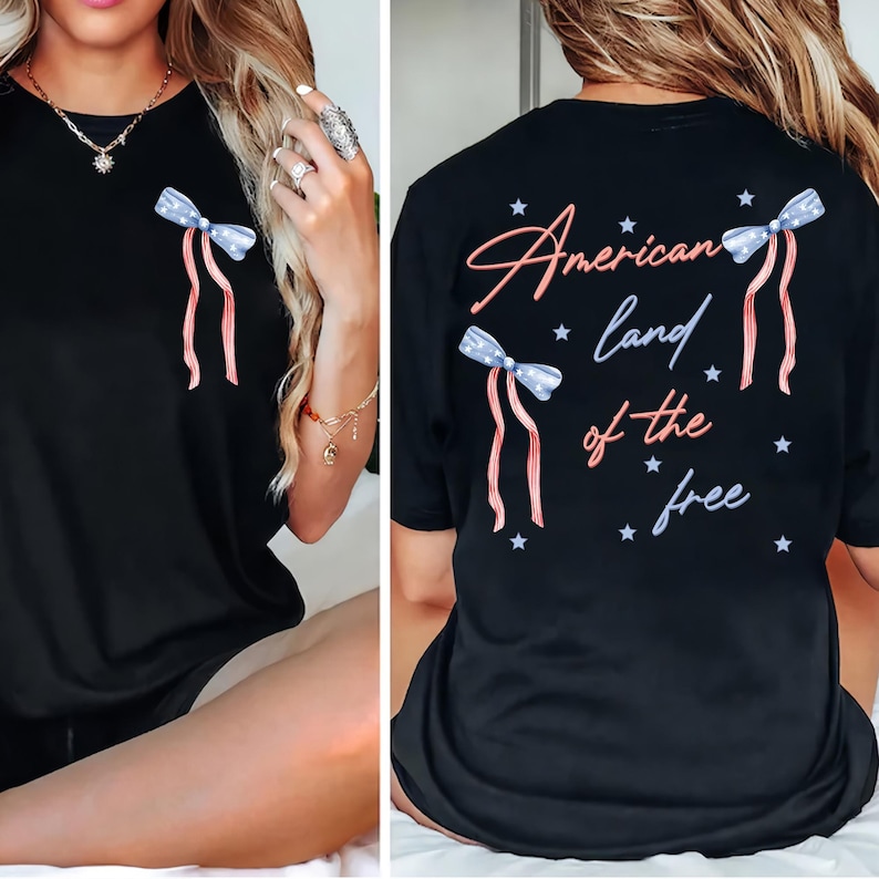 May include: Black t-shirt with a patriotic bow design on the front and back. The back of the shirt has the text "American land of the free" with star accents. The bows are blue with white stars and red and white striped ribbons.
