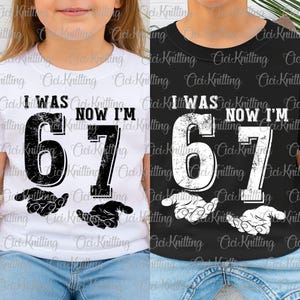 May include: Two t-shirts, one white and one black, each with the text "I WAS 67 NOW I'M" and the number "67" in a large, distressed font. Below the text are two hands pointing.