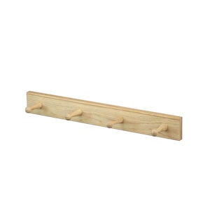 May include: A light-coloured wooden wall-mounted rack featuring a long rectangular base and four evenly spaced, tapered pegs extending outwards. The natural wood grain is visible across the entire surface of the rack, which has a smooth finish.