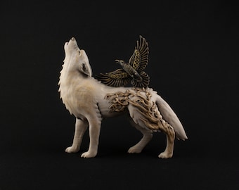 May include: A detailed sculpture of a howling wolf with a raven perched on its back. The wolf is off-white with intricate wood-like detailing. The raven has bronze-colored wings. The sculpture is set against a black background.