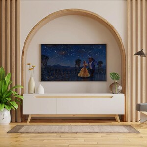 May include: A white entertainment center with wooden legs and a light wood trim. A large flat-screen TV displays a scene from Beauty and the Beast. Decorative vases and plants are on the entertainment center.