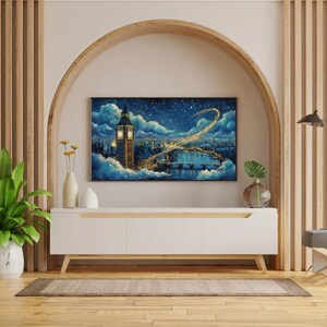 May include: A framed artwork depicting a nighttime cityscape of London, featuring Big Ben and the Thames River. The painting is set against a starry sky with swirling clouds. The artwork is displayed above a white cabinet with wooden legs, complemented by decorative vases and a potted plant.